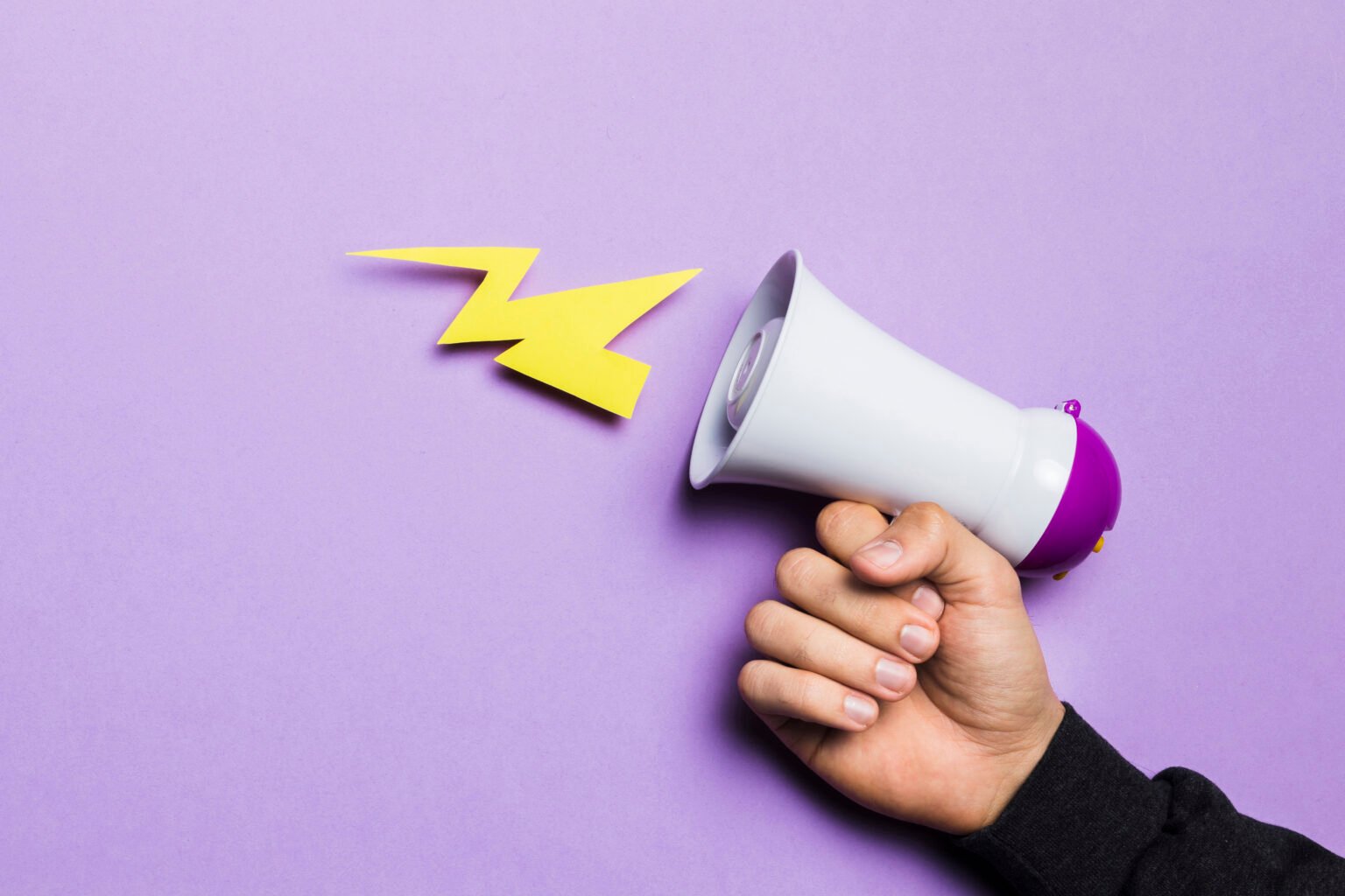 Woman's hand showing power and thunder with a megaphone